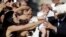 Pope Francis, right, blesses a baby as he arrives on the occasion of an audience with participants of Rome's diocese convention in St. Peter's Square, at the Vatican.