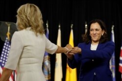 Democratic presidential candidate and former Vice President Joe Biden's wife, Jill Biden, and vice presidential candidate Senator Kamala Harris are seen on stage in Wilmington, Delaware, Aug. 12, 2020.