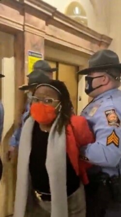 Police officers place state Rep. Park Cannon in handcuffs in the Capitol in Atlanta, March 26, 2021, in this still image obtained from a social media video. (Tamara Stevens/Reuters)