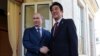 Russian President Vladimir Putin, left, and Japanese Prime Minister Shinzo Abe shake hands during their meeting in the Bocharov Ruchei residence in Sochi, Russia, Saturday, Feb. 8, 2014.