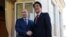 Russian President Vladimir Putin, left, and Japanese Prime Minister Shinzo Abe shake hands during their meeting in the Bocharov Ruchei residence in Sochi, Russia, Saturday, Feb. 8, 2014.