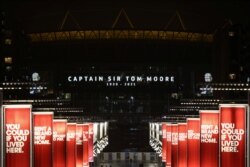 The Wembley Stadium is illuminated in commemoration of Captain Sir Tom Moore, after his family announced that the centenarian fundraiser died, in London, Britain, Feb. 2, 2021.