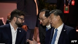 FILE —Chinese President Xi Jinping (R) speaks with Chilean President Gabriel Boric (L) through an interpreter at the APEC Leaders' Week in San Francisco, California, on November 16, 2023.