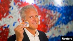 FILE - Stonegate Bank President David Seleski shows off a credit card during an interview in Havana, Cuba, June 8, 2016. 