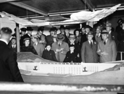 FILE - President Franklin D. Roosevelt looks at a model of the Grand Coulee Dam, Oct. 2, 1937. Construction began years earlier; Roosevelt had envisioned the project would fit into his New Deal under the Public Works Administration.