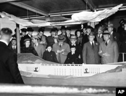 FILE - President Franklin D. Roosevelt looks at a model of the Grand Coulee Dam, Oct. 2, 1937. Construction began years earlier; Roosevelt had envisioned the project would fit into his New Deal under the Public Works Administration.