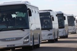 French passengers on buses leave a military air base in Istres, southern France, Jan.31, 2020, after arriving by plane from the virus-hit Chinese city of Wuhan.