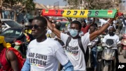 FILE — Supporters of the Aar Sunu Senegal opposition collective demonstrate on a street, in Dakar, on February 17, 2024. 