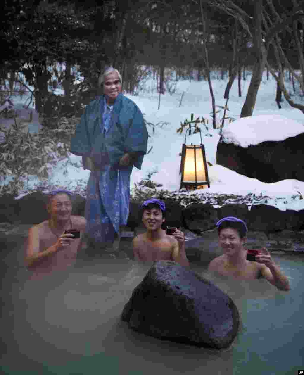Photographer Nick Ut (standing) met three Fukushima firefighters at a hot spring. (Photo by Mark Edward Harris)