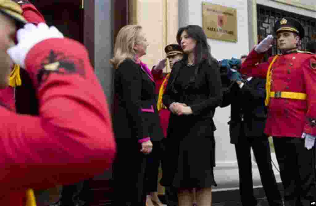 US Secretary of State Hillary Clinton, left, speaks with Albanian House Speaker Josefina Topalli, centre, after speaking to the Albanian Parliament in Tirana, Albania, Thursday, Nov. 1, 2012. Hillary Clinton arrived in EU-hopeful Albania on the last leg o