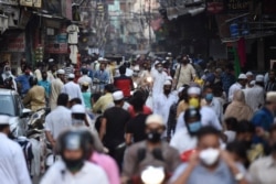 People gather at a market on the last Friday of Ramadan after the government eased restrictions imposed as a preventive measure against the spread of the coronavirus in the old quarters of New Delhi, India, May 22, 2020.