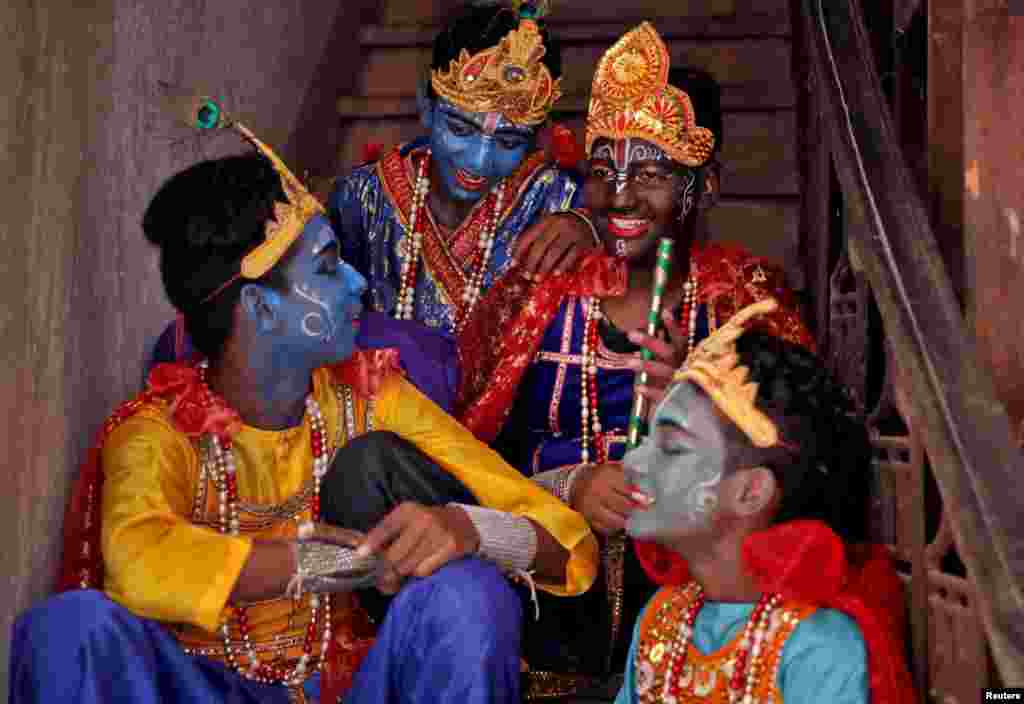 Boys dressed as Hindu Lord Krishna wait to perform at a temple during the festival of Janmashtami, marking the birth anniversary of Lord Krishna, in Kolkata, India.