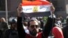 Man holds Egyptian flag with Arabic words “Tiran is Egyptian” in front of the Egyptian Administrative Court in Giza, Egypt, Jan 16, 2017. (Photo: Hamada Elrasam for VOA)