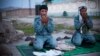 Afghan policemen pray at a checkpoint outside of Jalalabad, east of Kabul, in this March 18, 2013, file photo. 