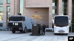 Security cars and an official stand outside the Justice Palace as a trial against Metin Topuz, a Turkish employee of the United States Consulate in Istanbul charged with espionage and attempting to overthrow the Turkish government, began in Istanbul, Marc