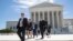 People leave the Supreme Court in Washington, June 26, 2017, as justices issued their final rulings for the term.