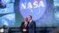 Vice President Mike Pence, left, shakes hands with the new NASA administrator Jim Bridenstine, right, on stage during a swearing-in ceremony, April 23, 2018, at NASA Headquarters in Washington. 