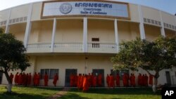 Cambodian Buddhist wait outside the court hall before they attending the hearings against two former Khmer Rouge senior leaders, at the U.N.-backed war crimes tribunal on the outskirts of Phnom Penh, Cambodia, Friday, Nov. 16, 2018. 