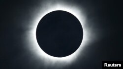 FILE - A solar eclipse is seen from the beach of Ternate island, Indonesia, March 9, 2016. 