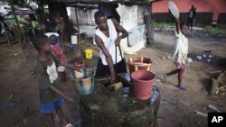 Boys collect water at a well in Liberia's capital Monrovia. (File Photo)