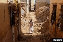 FILE - A man inspects damaged buildings, in the aftermath of a deadly storm and flooding that hit Libya, in Derna, Libya September 20, 2023.