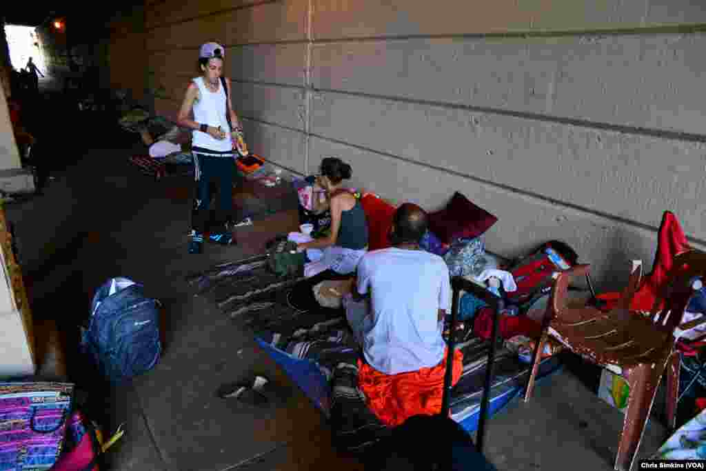 Intravenous drug users who are homeless camp under a railroad bridge where they sleep, eat and use heroin, due to the cleanup of &ldquo;The Tracks.&rdquo;