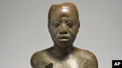 Seated figure, Tada, Ife. Copper, early 14th century