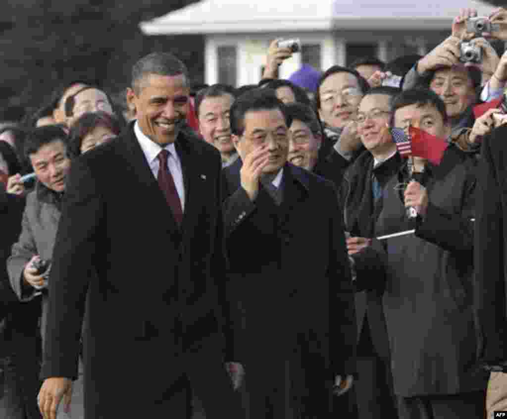 President Barack Obama and China's President Hu Jintao greet guests during a state arrival ceremony at the White House in Washington, Wednesday, Jan. 19, 2011. (AP Photo/Susan Walsh)