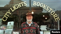 FILE - Lawrence Ferlinghetti stands outside his bookstore in San Francisco, California, Aug. 18, 1998. 