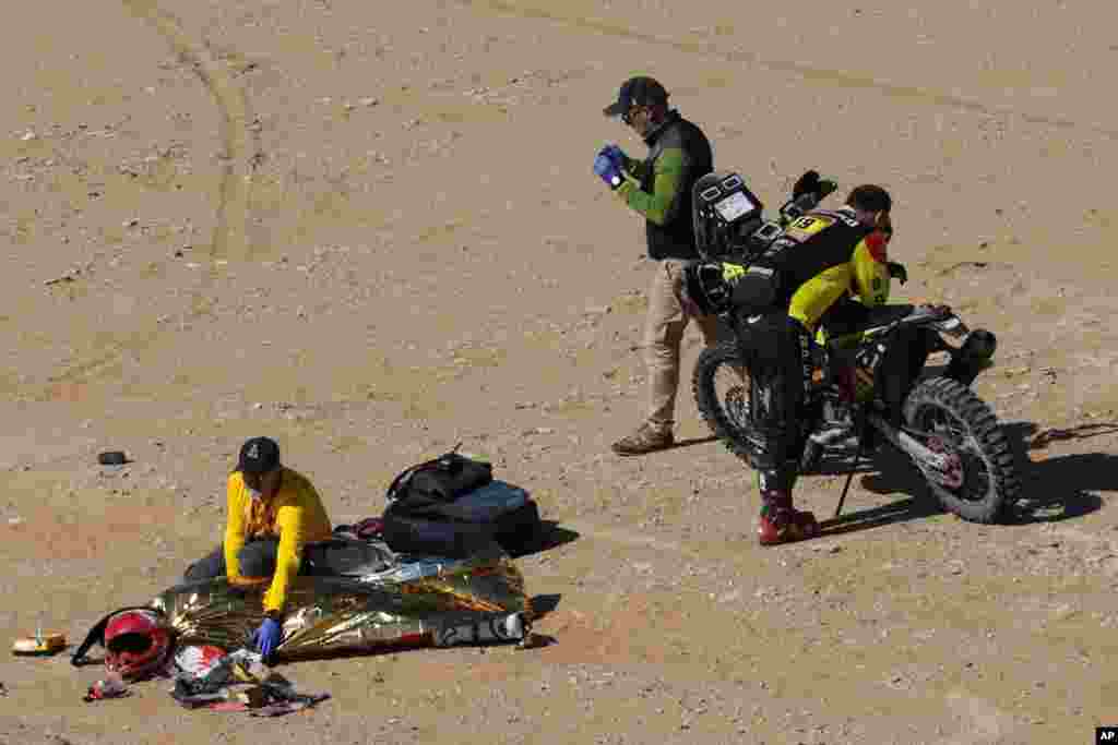 The body of Paulo Gon&#231;alves of Portugal is covered with a blanket after a deadly fall during stage seven of the Dakar Rally between Riyadh and Wadi Al Dawasir, Saudi Arabia.