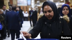 An Iranian woman casts her vote during parliamentary elections at a polling station in Tehran, Iran, Feb. 21, 2020. 