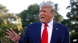 FILE - President Donald Trump speaks to members of the media on the South Lawn of the White House in Washington, Oct. 10, 2019, before boarding Marine One.