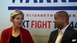 Democratic presidential contender and U.S. Senator Elizabeth Warren speaks with state Senator Marlon Kimpson during a campaign stop in Charleston, South Carolina, Oct. 9, 2019.