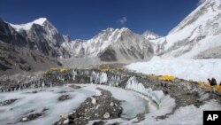 FILE - Tents are seen set up for climbers on the Khumbu Glacier, with Mount Khumbutse (C) and Khumbu Icefall (R) seen in background, at Everest Base Camp in Nepal, April 11, 2015.