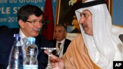Turkish Foreign Minister Ahmet Davutoglu, left, chats with Qatar's Prime Minister and Foreign Minister Sheik Hamad bin Jassim al-Thani at a meeting of the Friends of the Syrian People in Marrakech, Morocco, Wednesday, Dec. 12, 2012.
