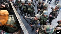 One of the military's first battalions to be deployed in the city of Marawi board a military truck as they arrive to a hero's welcome at Villamor Air Base, Oct. 20, 2017, in Pasay city, southeast of Manila, Philippines. The military has begun to scale do