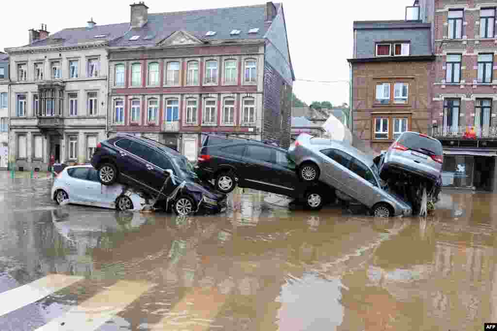 Cars are piled up by the water at a roundabout in the Belgian city of Verviers, after heavy rains and floods lashed western Europe.