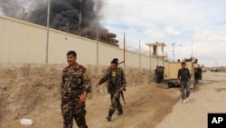 Smoke rises from a building, where Taliban insurgents hide during a firefight with Afghan security forces, in Helmand province, southwest Afghanistan, March 9, 2016.