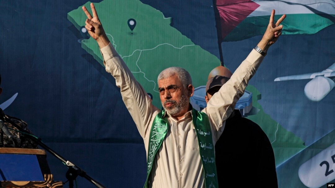 (FILES) Yahya Sinwar, leader of the Palestinian Hamas movement in the Gaza Strip, gestures on stage during a rally in Gaza City on May 24, 2021.