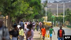 People walk on July 6, 2019 in the streets of Zalambessa, a town where battered buildings highlight the damage wrought by the Ethiopia-Eritrea border war, which erupted in 1998 and left tens of thousands of people dead.