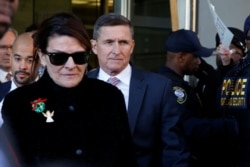 FILE - Former White House national security adviser Michael Flynn departs after his sentencing was delayed at U.S. District Court in Washington, Dec. 18, 2018.