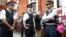 British police guard the Ecuadorian Embassy as protesters in support of Wikileaks founder Julian Assange demonstrate outside the embassy in London, May 20, 2019. 