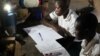 Michael Mugerwa’s students come to his house to study using his solar light, Kiwumu, Uganda, Feb. 28, 2014. (Hilary Heuler/VOA)