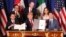 President Donald Trump, center, sits between Canada's Prime Minister Justin Trudeau, right, and Mexico's President Enrique Pena Nieto after they signed a new U.S.-Mexico-Canada Agreement that is replacing the NAFTA trade deal. 