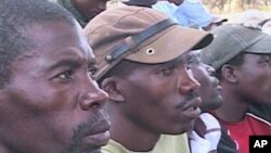 People listen to Constitution Outreach Program leaders in the farming district of Chinoyi, Zimbabwe, 24 July 2010