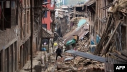 A man walks through rubble of houses damaged by the earthquake in Bhaktapur near Kathmandu, Nepal, April 28, 2015. 