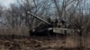 Ukrainian service members ride atop of a tank outside of the frontline town of Bakhmut, amid Russia's attack on Ukraine, in Donetsk region, Ukraine, March 4, 2023. 