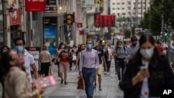 Pedestrians wearing face masks to prevent the spread of coronavirus walk in downtown Madrid, Spain, Sept. 17, 2020. 