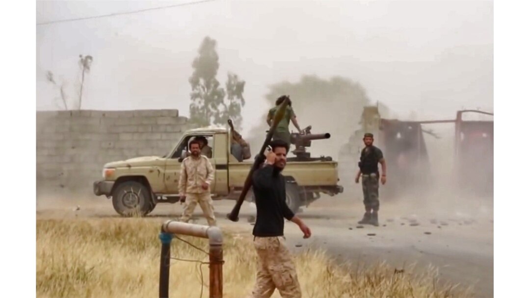 FILE - An image grab from a video reportedly shows fighters of Libyan military strongman Khalifa Haftar's self-proclaimed Libyan National Army on a road south of the capital Tripoli, May 26, 2019.