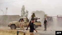 Fighters of Libyan military strongman Khalifa Haftar's self-proclaimed Libyan National Army on a road south of the capital Tripoli, May 26, 2019.